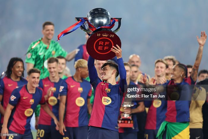 BARCELONA, SPAIN - MAY 18: Pedri of FC Barcelona lifts the La Liga EA Sports title trophy following the La Liga EA Sports match between FC Barcelona and Villarreal CF at Estadi Olimpic Lluis Companys on May 18, 2025 in Barcelona, Spain. (Photo by Flor Tan Jun/Getty Images)