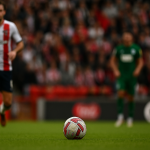 football player about to kick the ball