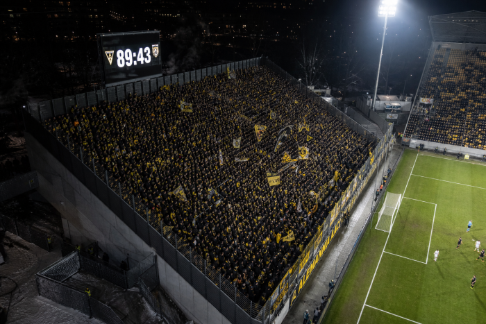 _thousands-of-fans-cheer-passionately-at-a-football-match_
