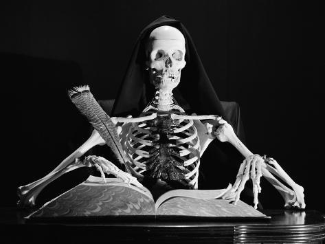 still-life-of-skeleton-writing-in-large-book-with-quill-pen.jpg