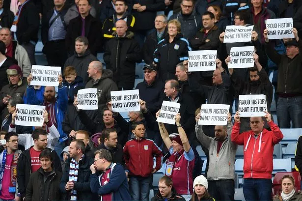 Aston-Villa-supporters-hold-banners-prior-to-the-Barclays-Premier-League-match-between-Aston-Villa-and-Chelsea-at-Villa.jpg