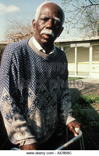 elderly-man-with-white-hair-leaning-on-his-zimmer-frame-uk-ae8b8c.jpg