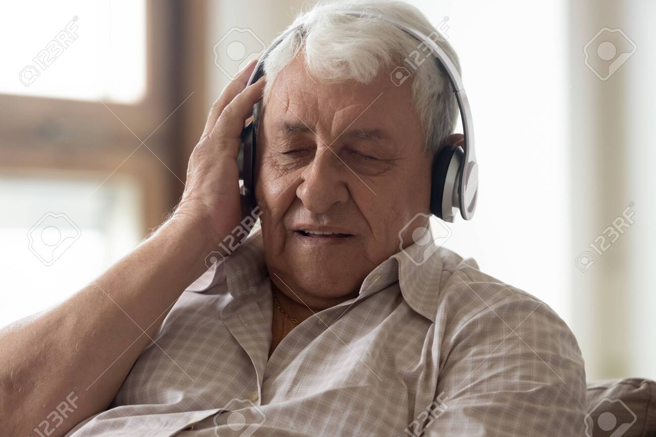 139912809-close-up-of-modern-elderly-man-wearing-bluetooth-headphones-enjoy-favorite-music-with-eyes-closed-ca.jpg